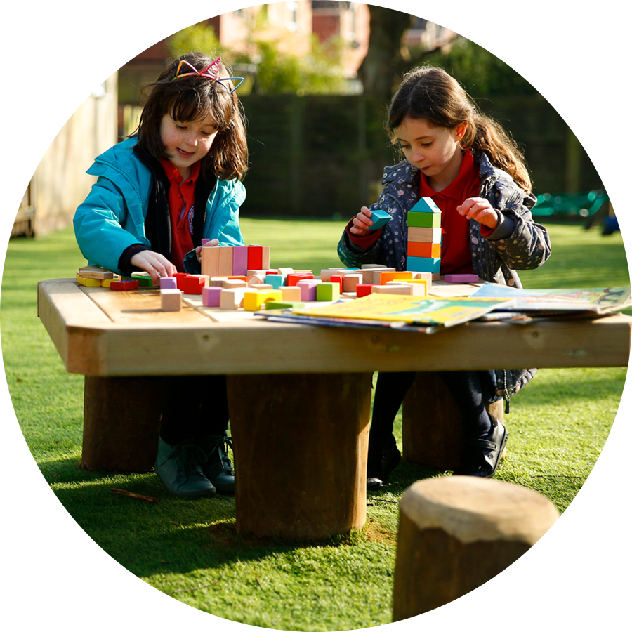 children playing with blocks on a wooden table