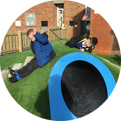 children on a play grass tunnel