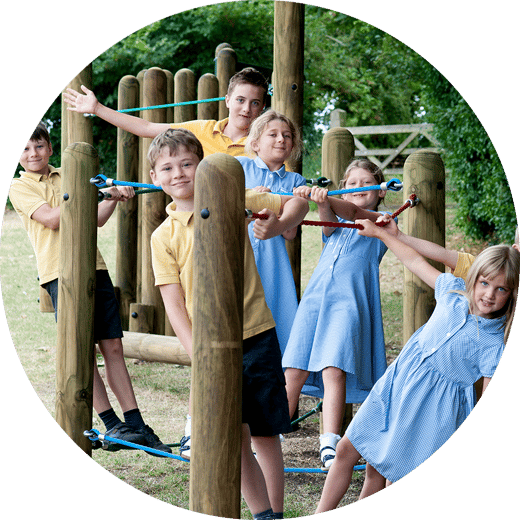 children playing on a playground low ropes course