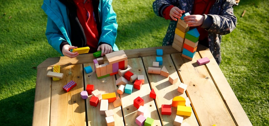 children playing with wooden building blocks