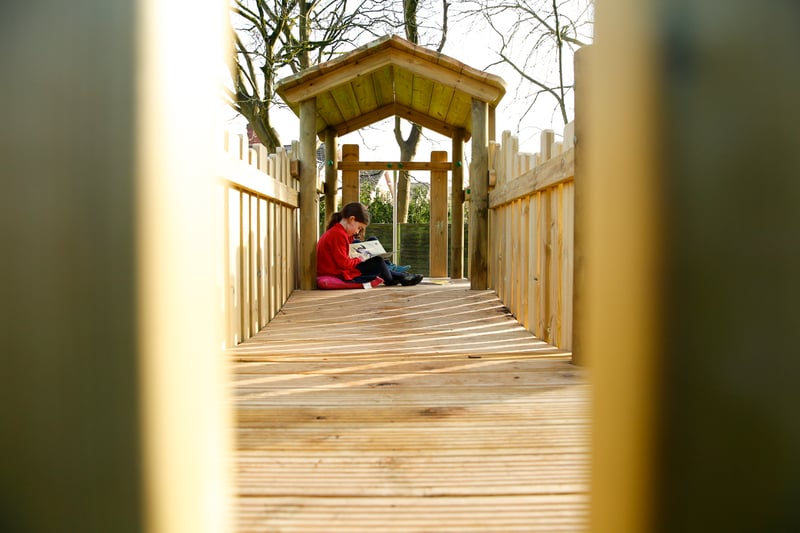 a girl reading in a play tower